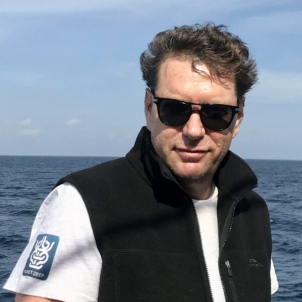 Oceanic Society naturalist, Benjamin Kahn posing in front of open water