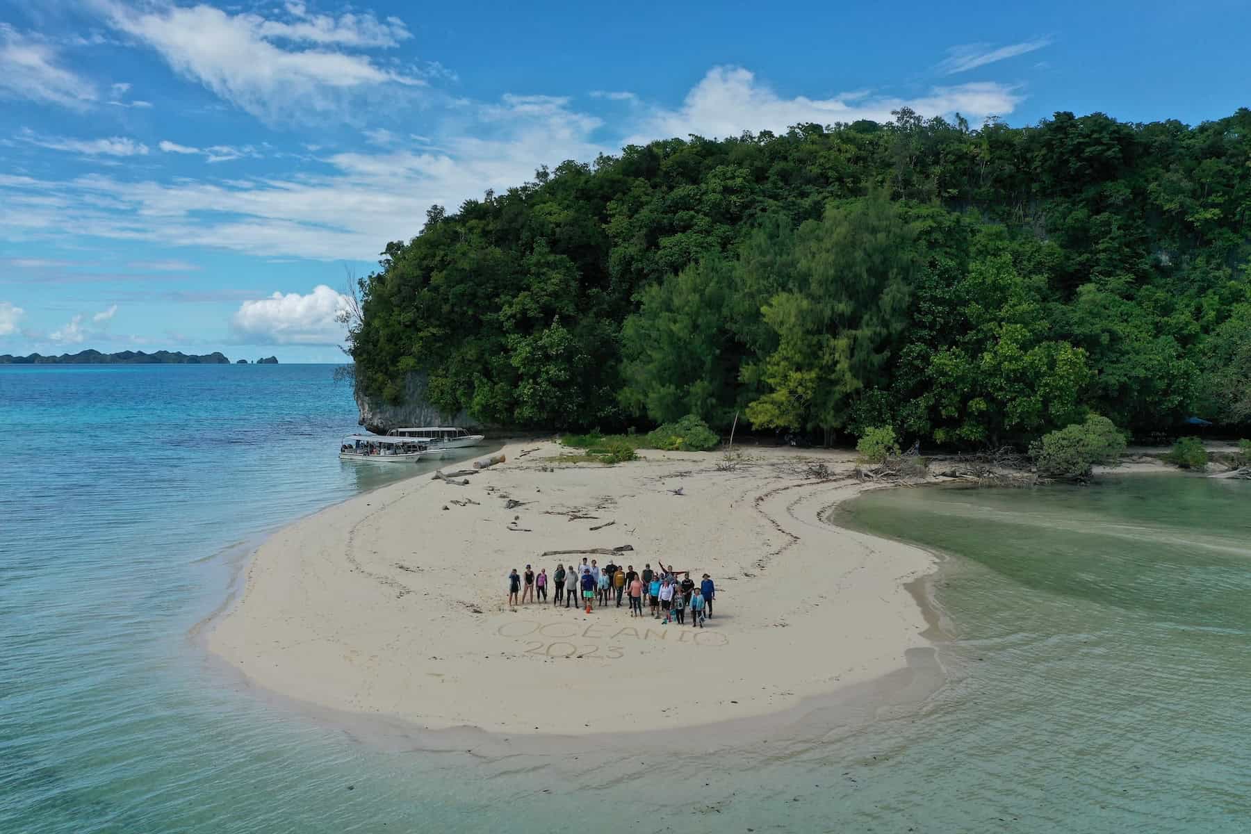 Drone photo of travelers standing together for photo in Palau's Rock Islands. Trip led by Oceanic Society. 