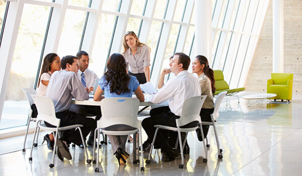 business people sitting and talking around a table