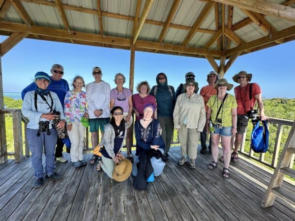 Solo travelers pose together on an Oceanic Society expedition in Belize, smiling and enjoying the experience as a group.
