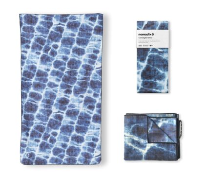 Lightweight, sand-resistant Nomadix microfiber towel made from recycled materials, ideal for beach or snorkeling trips.